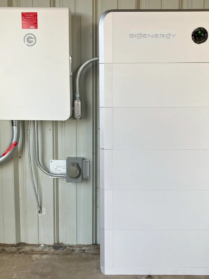 Real Houston customer install: Eos battery and electrical sub panel mounted indoors on a workshop wall, no outdoor box, curb stays clean, HOA stays quiet